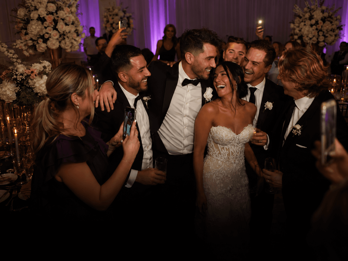 Wedding guests celebrating around the newly married couple